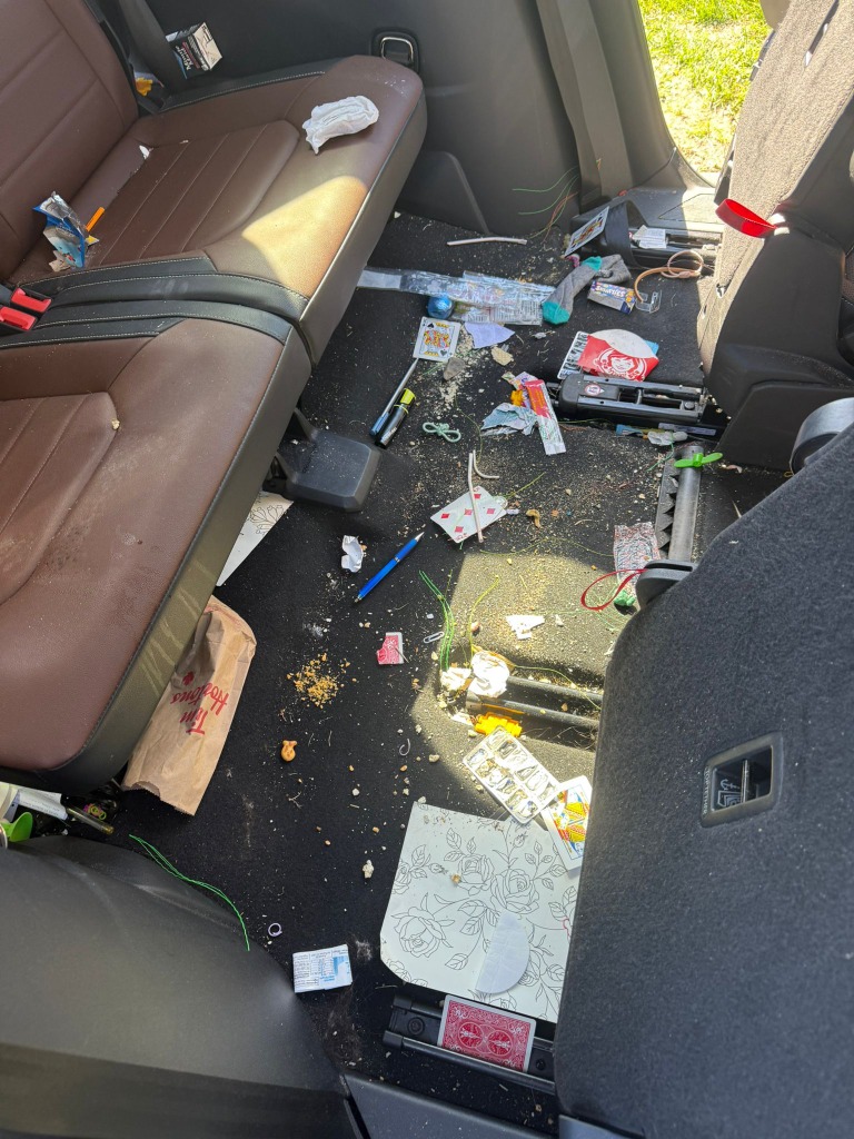 Automotive interior showing dirt and debris before detailing in Kingston